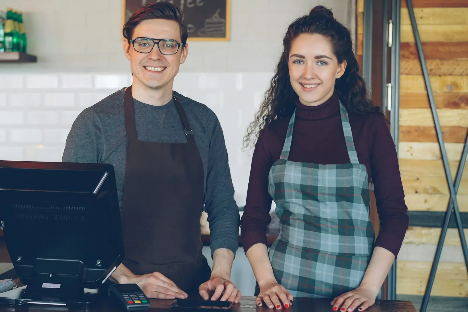 Two entrepreneurs behind the counter of their shop