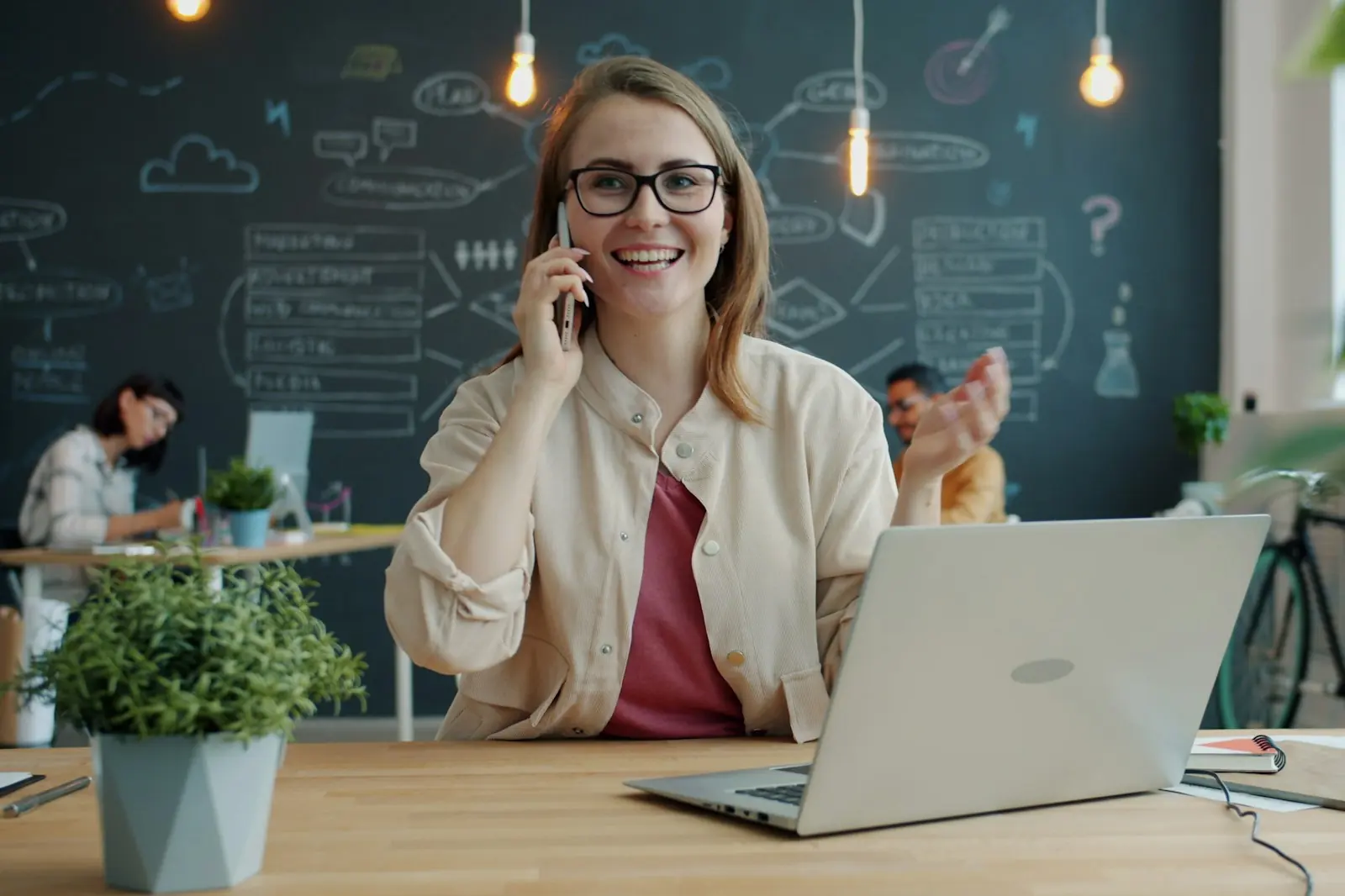 Employee on the phone behind her laptop at the office